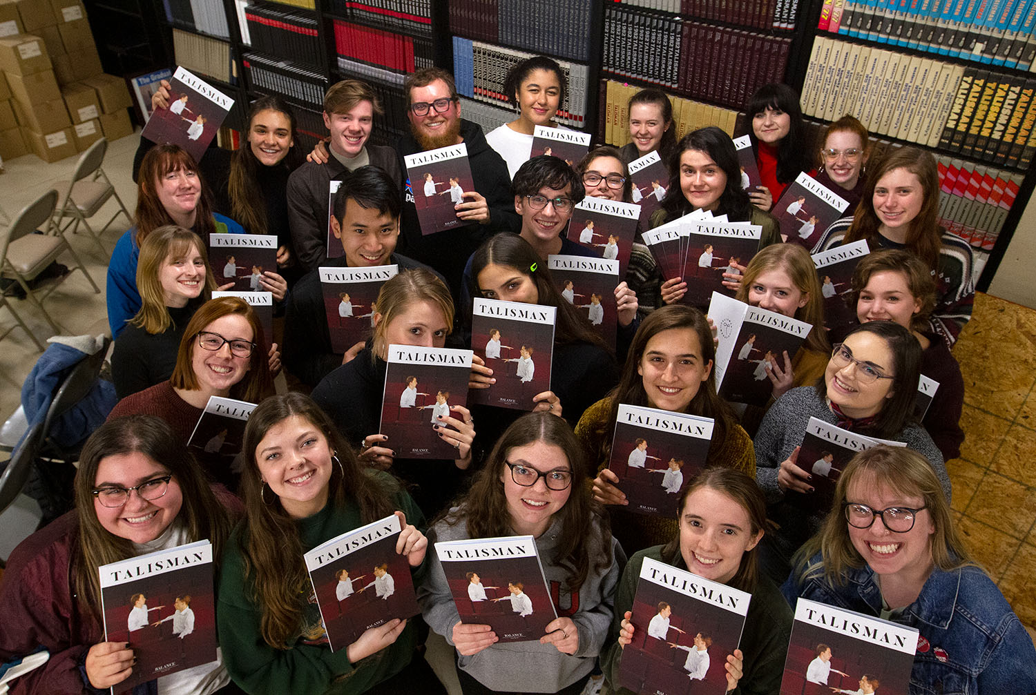 Talisman staff members celebrate the arrival of the Talisman magazine at the end of the fall 2019 semester.