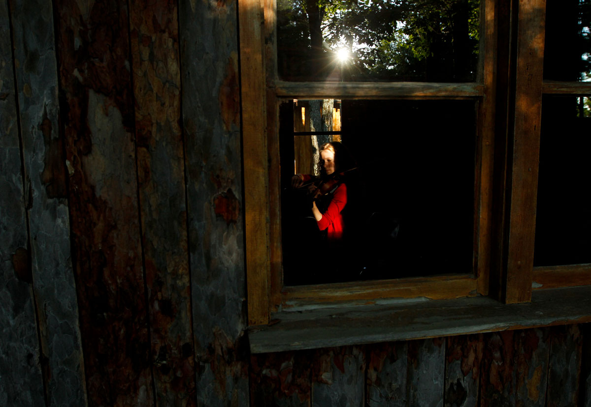 A student musician rehearses in a practice hut during her evening free time at Interlochen Arts Camp in northern Michigan. Now in its 83rd year, the camp is attended by around 2,500 students between the ages of 8 and 18 for two, three or six week stints. 