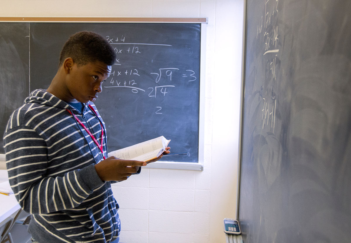 Ni'Kerrion McDonald of Lexington works out a problem on the chalkboard in Mathematics Friday, July 1 during VAMPY.