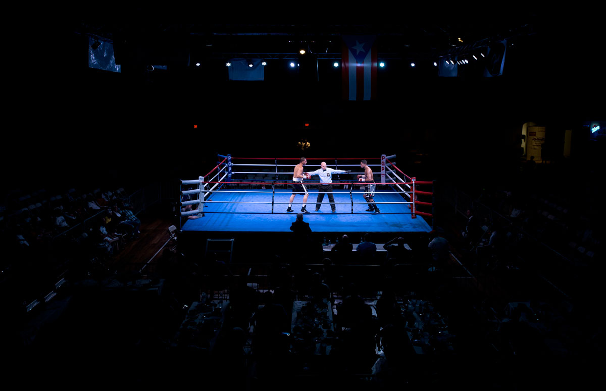 A New York State Athletic Commission official separates two boxers during the Throwdown at the Armory II put on by Pretty Girl Productions Aug. 23 at the Main Street Armory in Rochester.