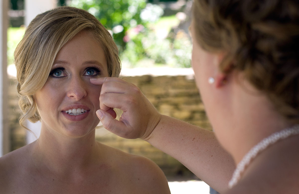 Beth wipes tears from Kari's eyes after she saw Brandon for the first time on their wedding day.