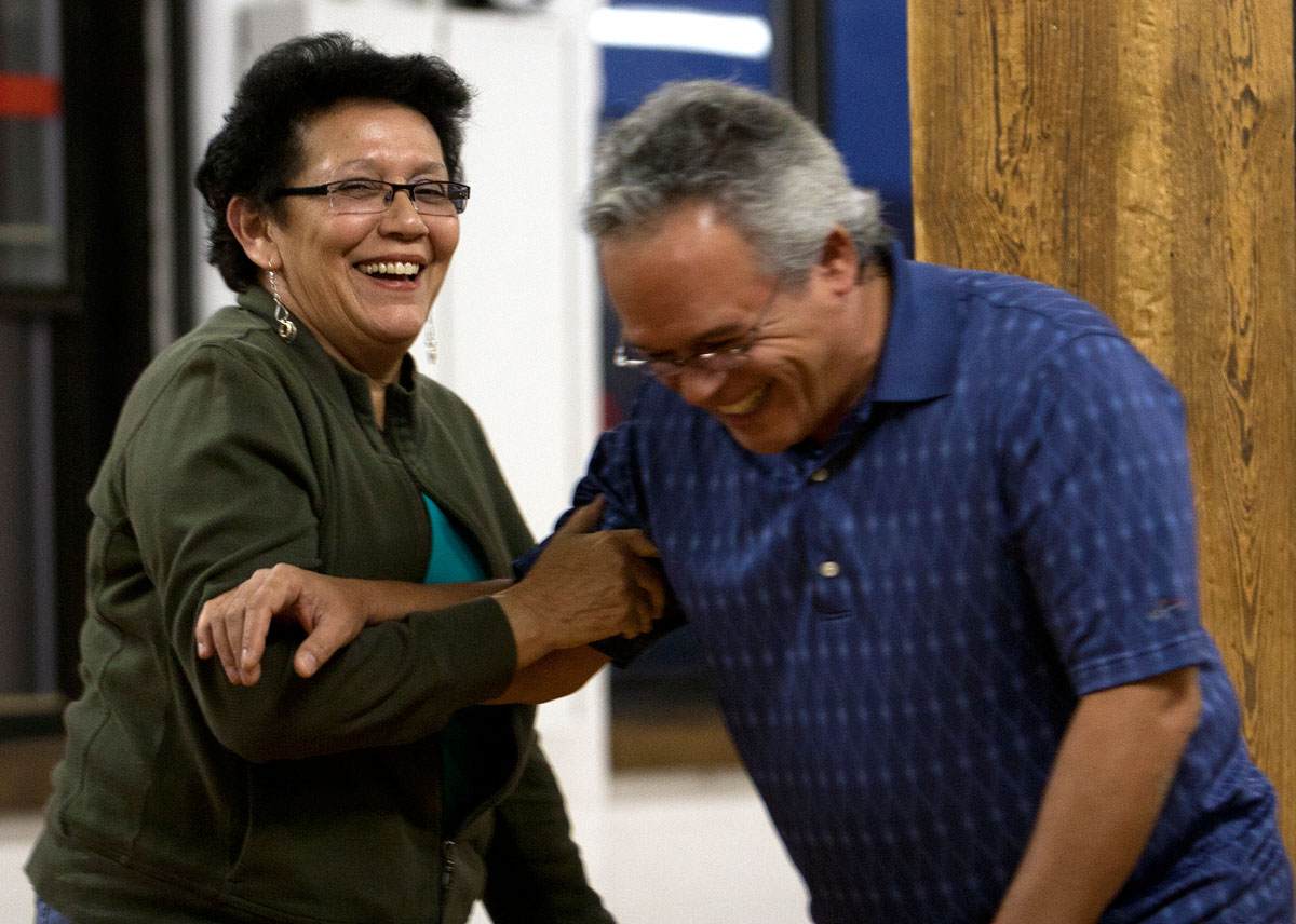 Nydia Rivera laughs with John Rodriguez after he fumbles several lines during rehearsal for "Macho's Place," a play written and directed by Rivera, Sept. 24 at Shoshin in Rochester. The actors speak in a combination of Spanish and English throughout the play.