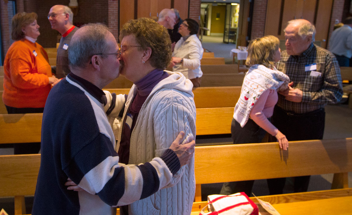 Couples kiss after renewing their wedding vows during a retreat at Notre Dame Retreat House in Canandaigua Feb. 15.