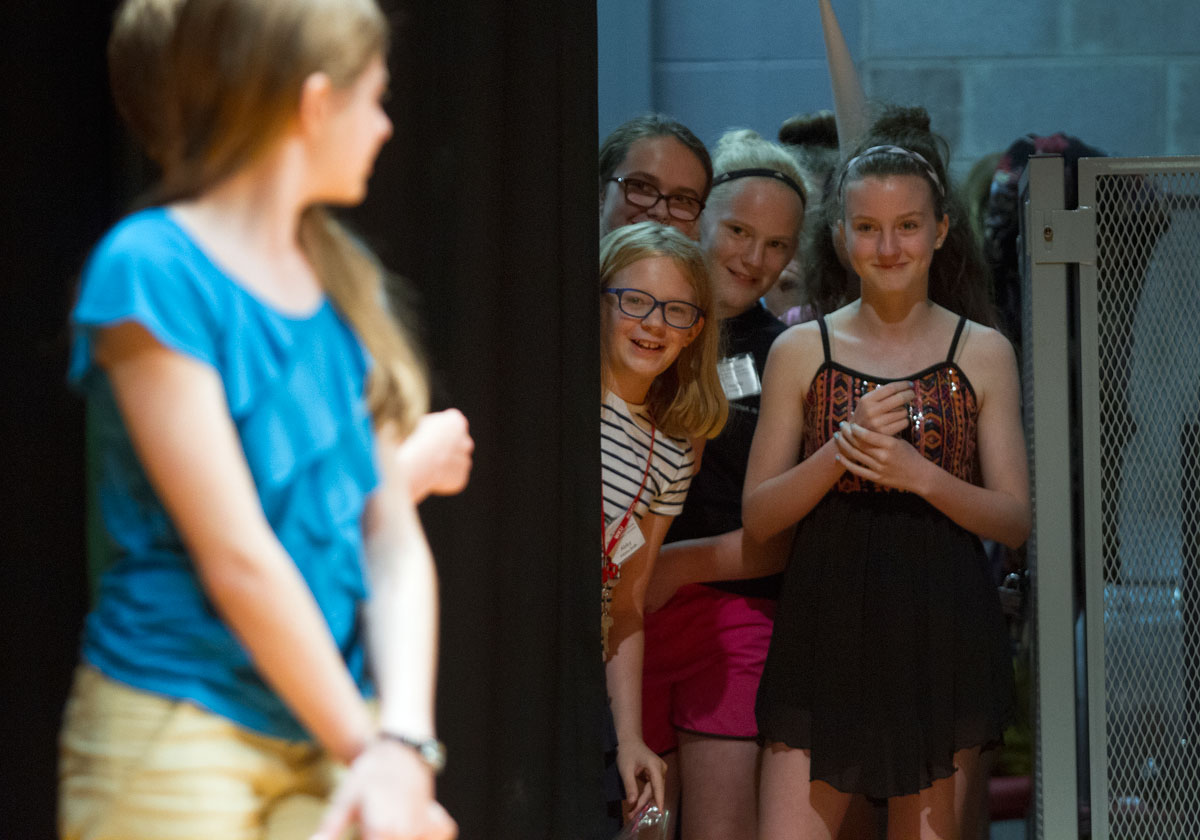 Abby Adams-Smith (from left) of Bowling Green, Chloe Paddack from Falls of Rough, Cassidy Burnside of Vallonia, Ind., and Emma North of Owensboro watch an introduction presented by the emcees before their group's performance in the SCATS Talent Show Wednesday, June 17.