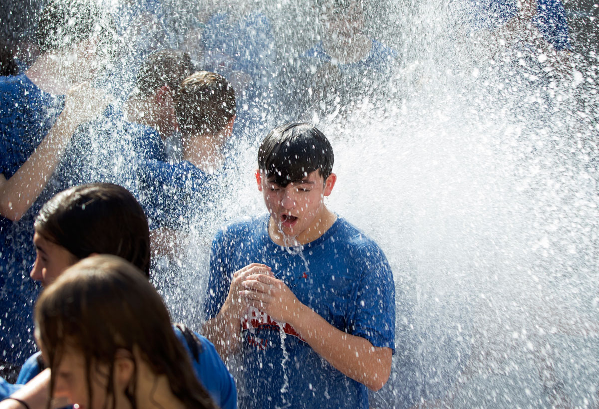 Campers take the traditional run through the fountain outside Margie Helm Library after the last day of classes Friday, July 15.
